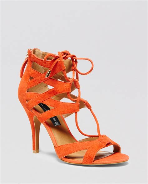 ladies orange heeled sandals.